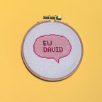 Embroidery hoop with 'EW DAVID' text on a yellow background